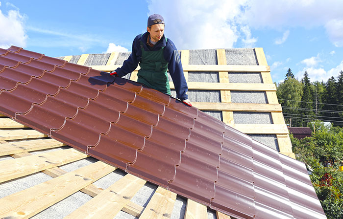 man installing metal roof