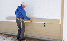 man installing siding