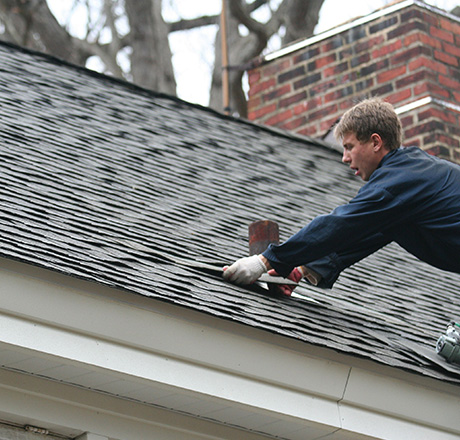Man installing shingle roof